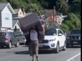 Man Carrying Couch Takes up a Lane