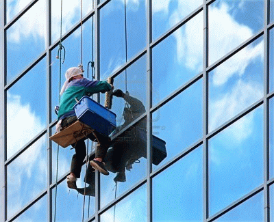 7681868-window-cleaner-hanging-on-rope-at-work-on-skyscraper